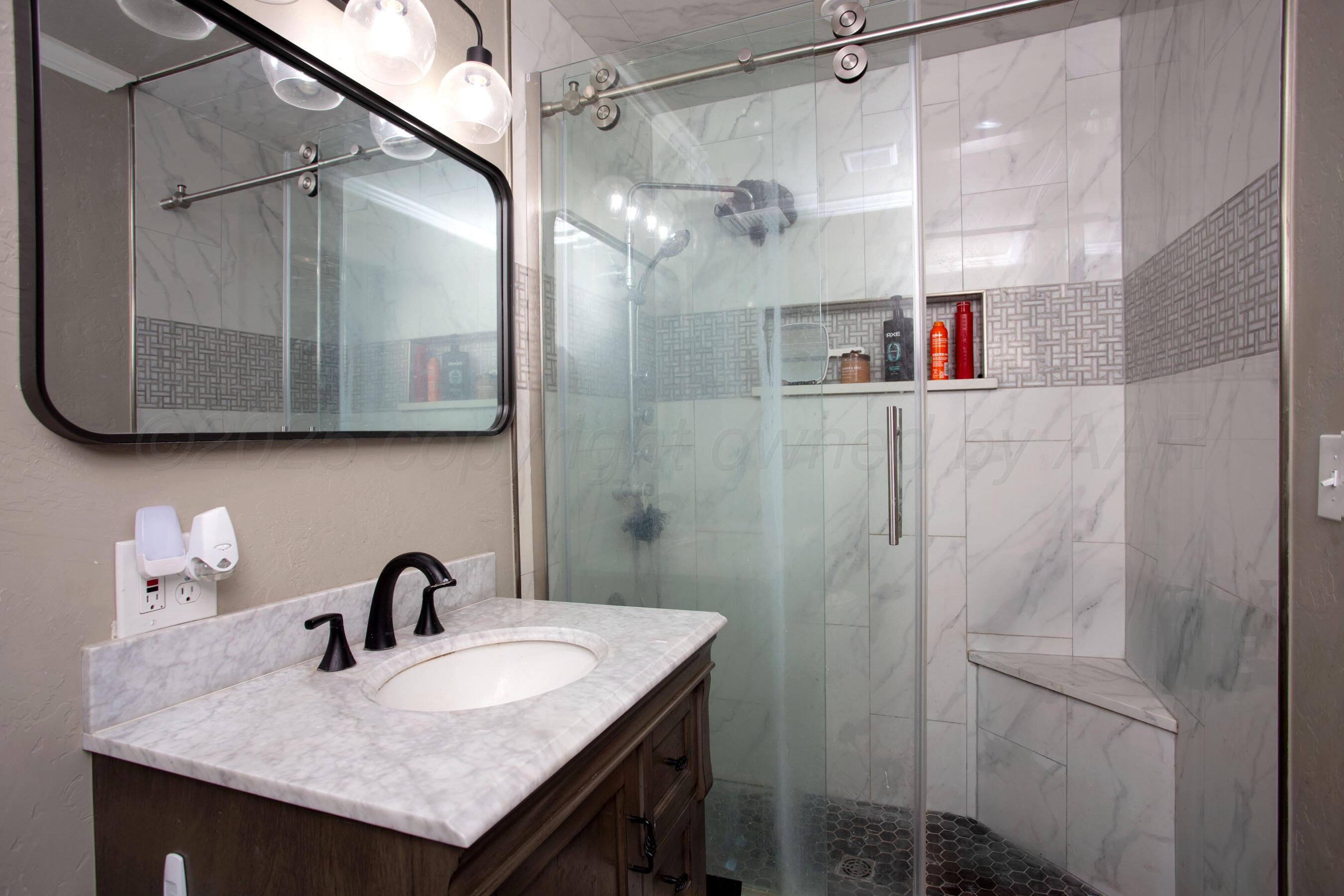 4409 South Lipscomb Street Amarillo, TX 79110 - Photo 16 of 23 a bathroom with a sink and a mirror