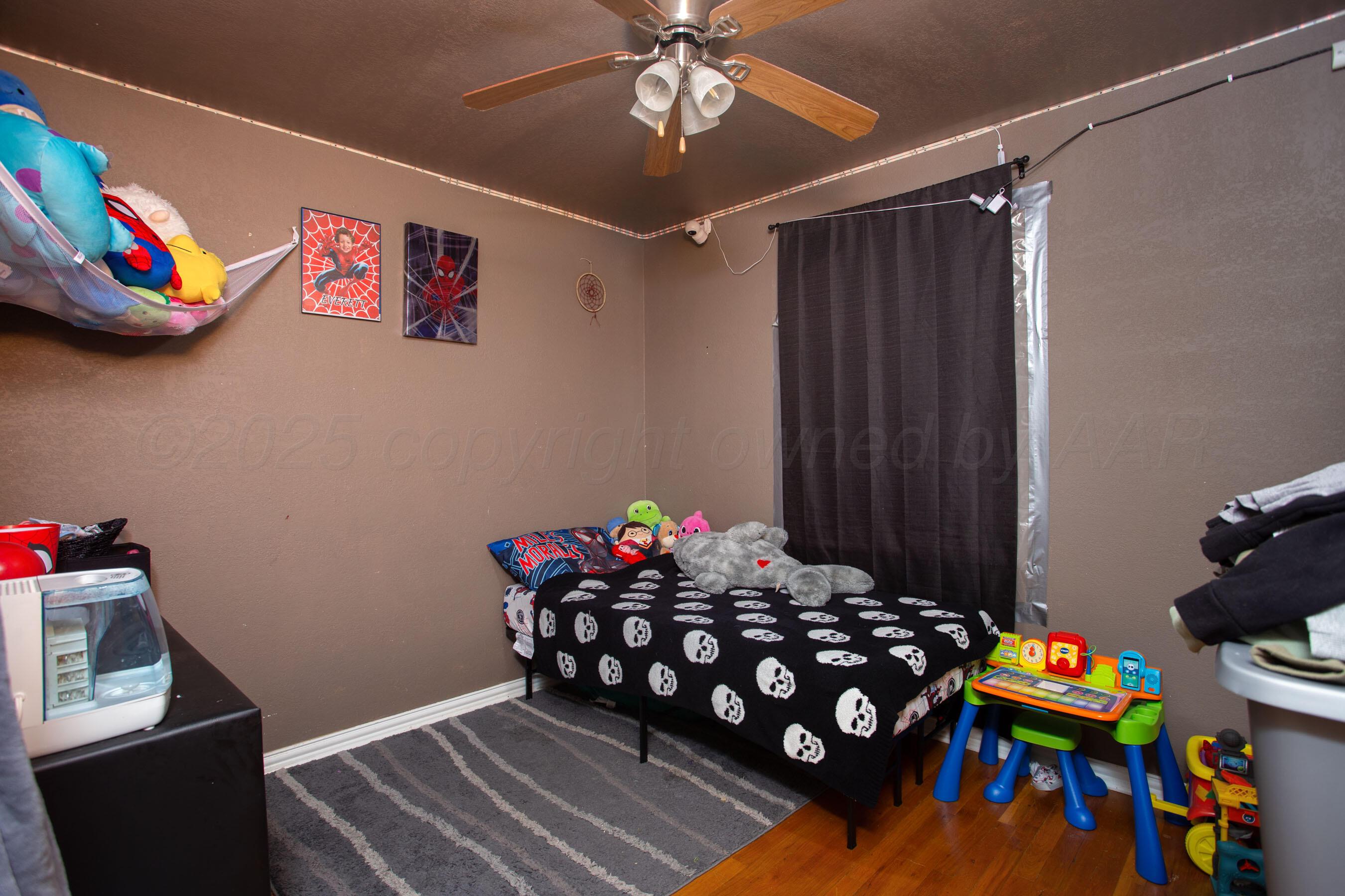 4409 South Lipscomb Street Amarillo, TX 79110 - Photo 19 of 23 a bedroom with a bed and a chandelier