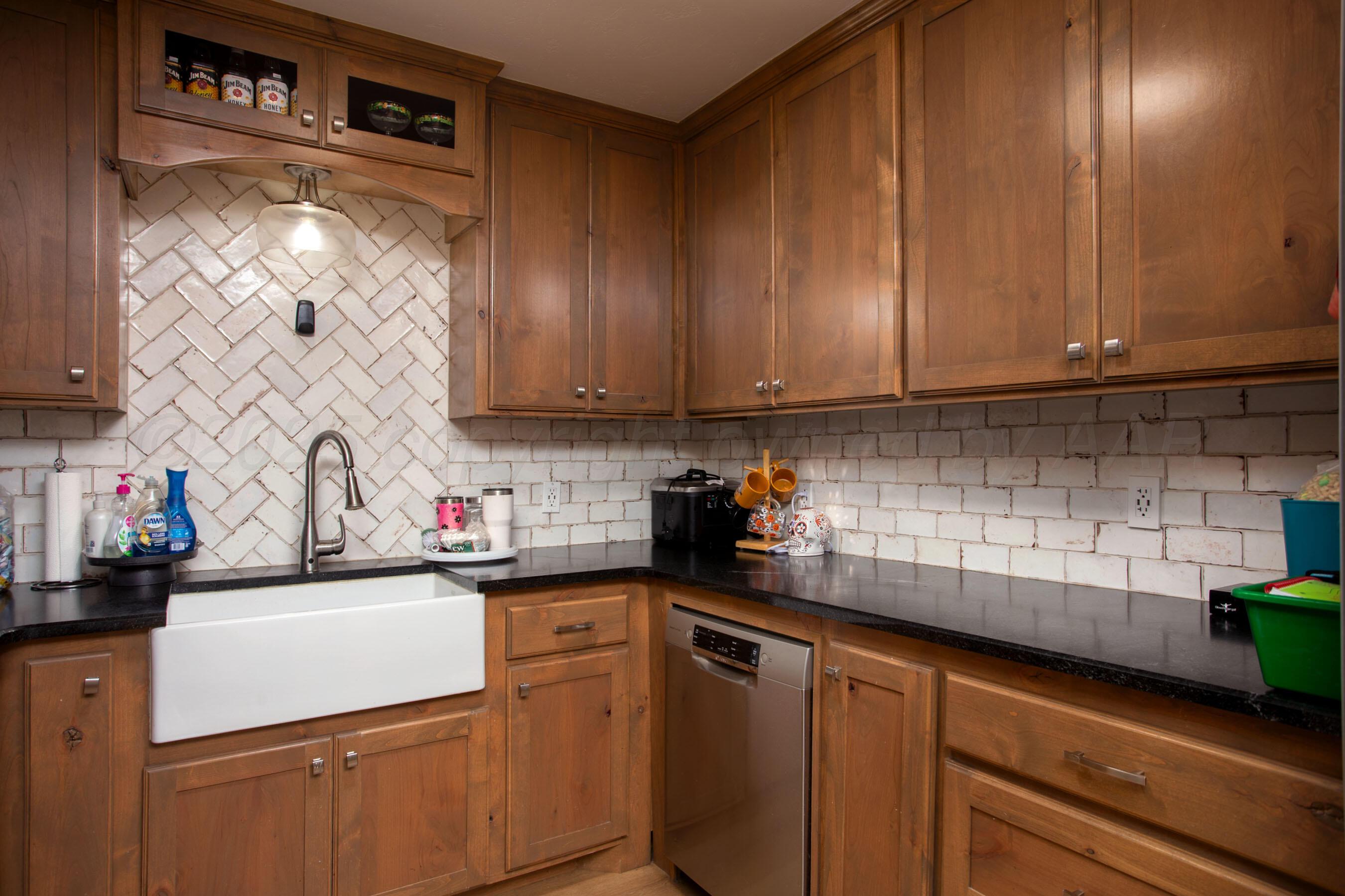 4409 South Lipscomb Street Amarillo, TX 79110 - Photo 9 of 23 a kitchen with a sink and cabinets