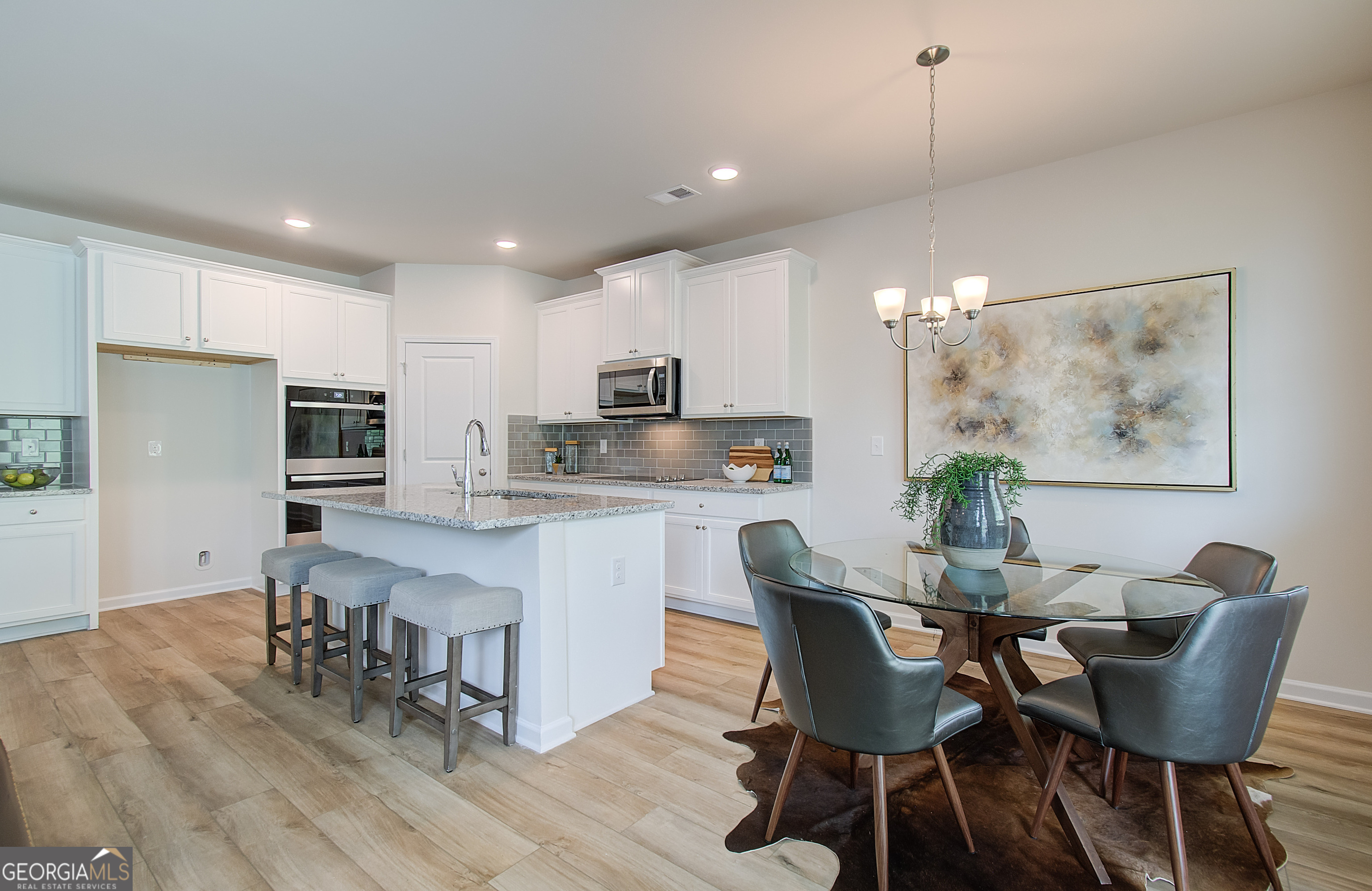 477 Collier Mls Road, Unit 20 Lawrenceville, GA 30045 - Photo 15 of 36 a dining room with furniture and wooden floor
