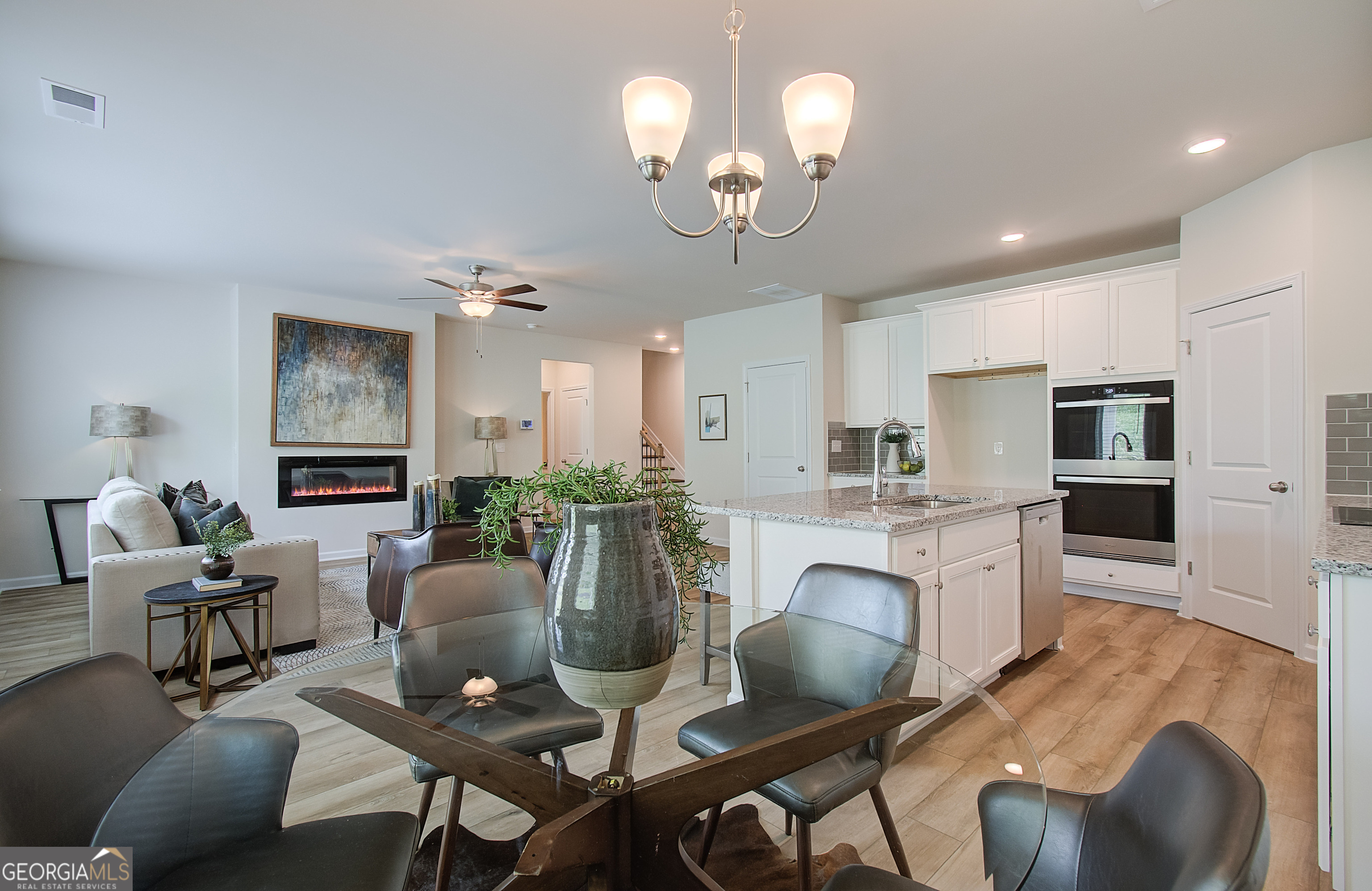 477 Collier Mls Road, Unit 20 Lawrenceville, GA 30045 - Photo 17 of 36 a view of a dining room with furniture a livingroom and chandelier