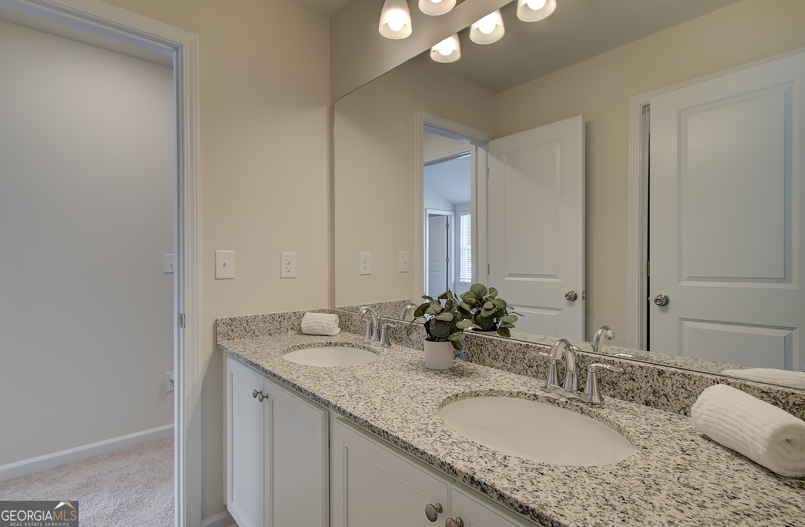 477 Collier Mls Road, Unit 20 Lawrenceville, GA 30045 - Photo 24 of 36 a bathroom with a granite countertop double vanity sink and a mirror