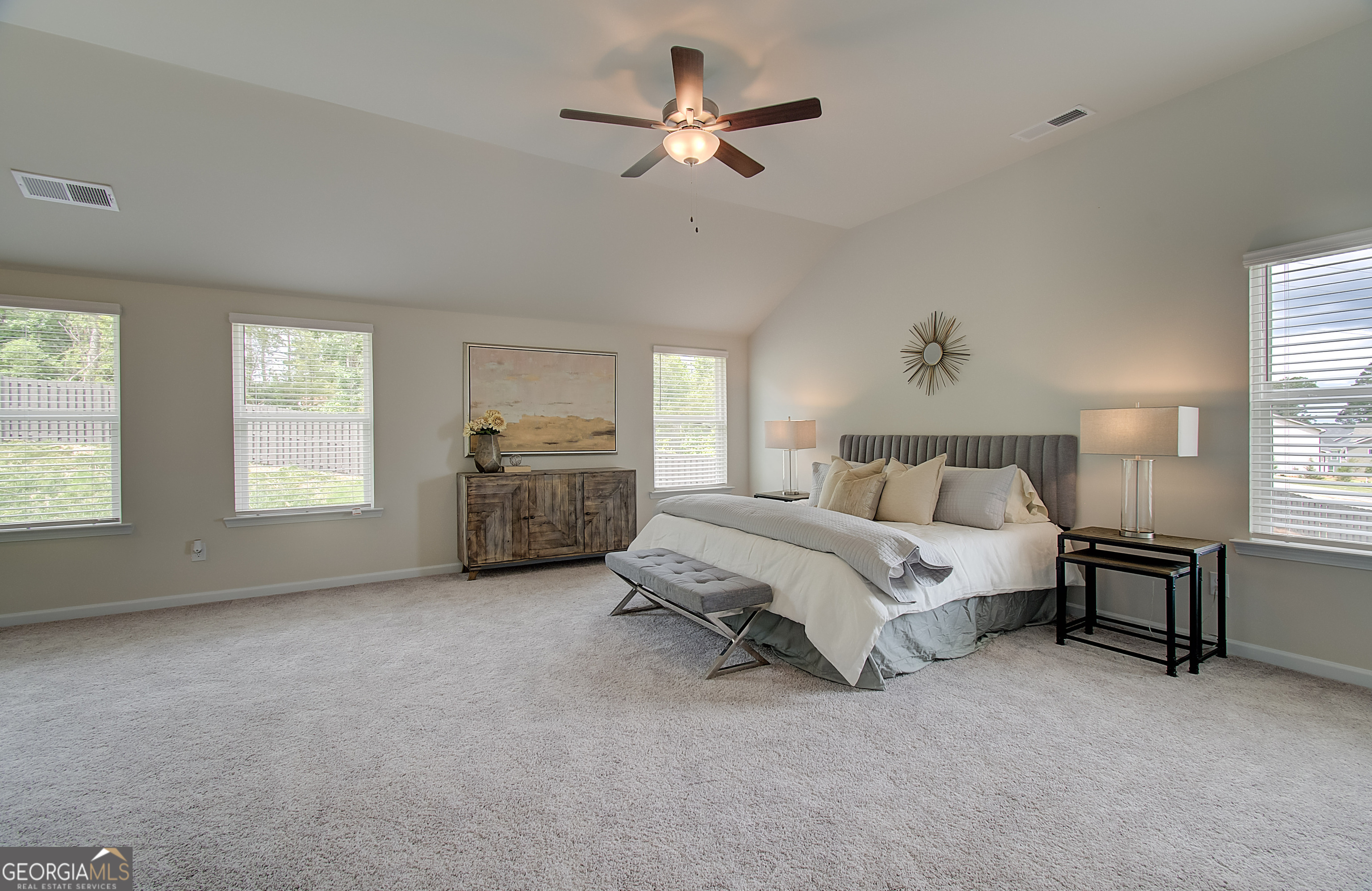 477 Collier Mls Road, Unit 20 Lawrenceville, GA 30045 - Photo 27 of 36 a spacious bedroom with a bed a table and chair