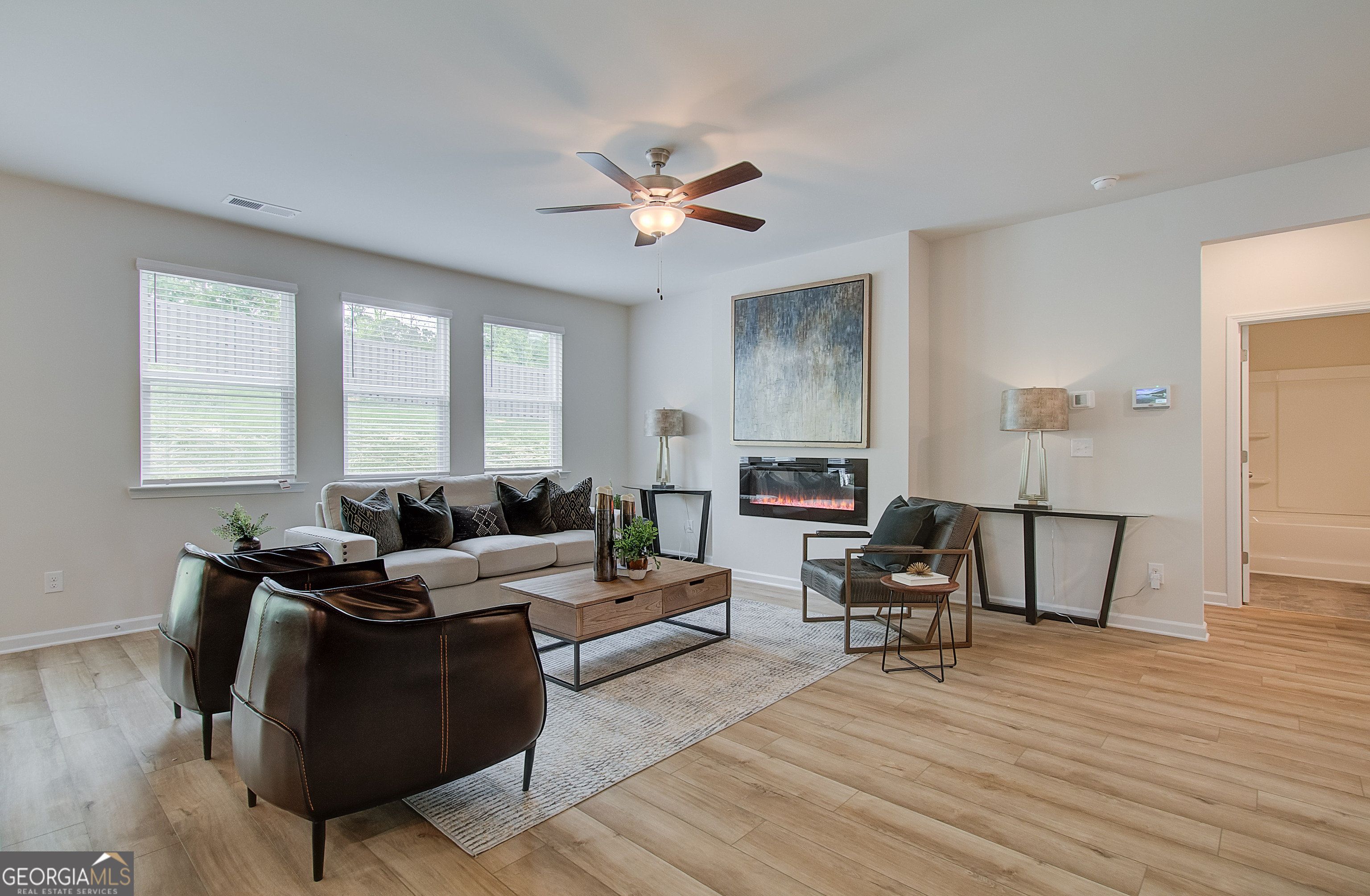 477 Collier Mls Road, Unit 20 Lawrenceville, GA 30045 - Photo 10 of 36 a living room with furniture and a wooden floor
