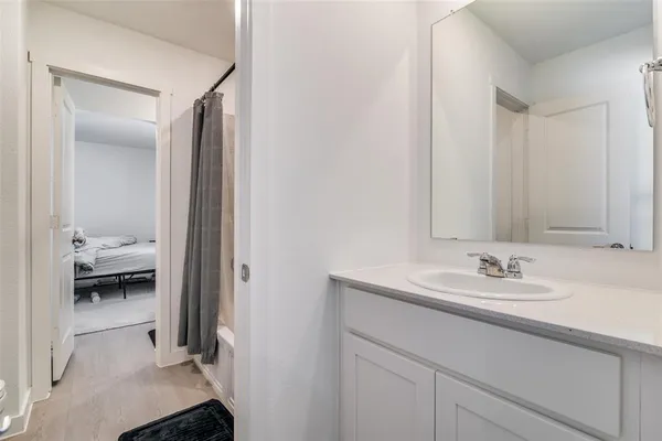 a en suite bathroom with a sink and a mirror