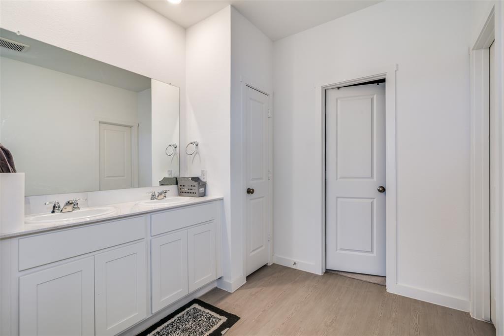 4016 Daisy Holw Loop Mesquite, TX 75181 - Photo 13 of 32 a spacious bathroom with a double vanity sink a mirror and a