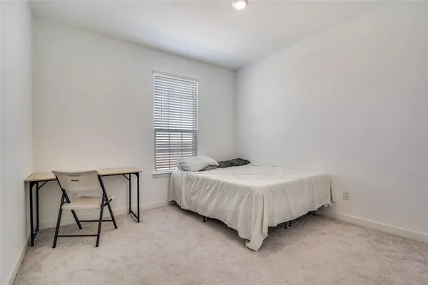 a bedroom with a bed chair and a window
