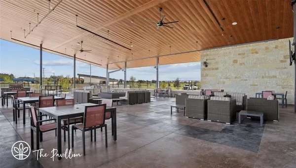 a view of a patio with dining table and chairs