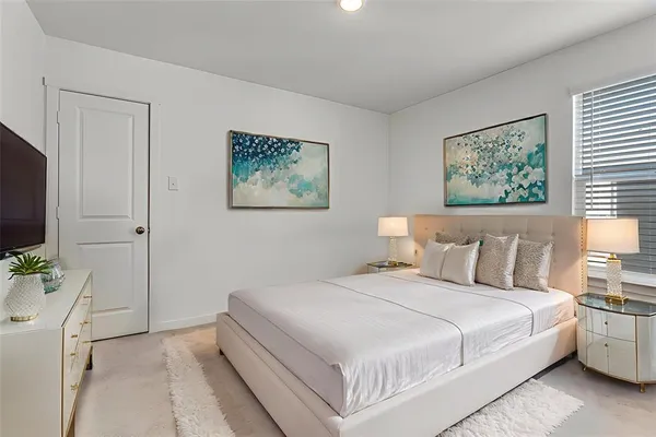 a bedroom with a bed and a flat screen tv