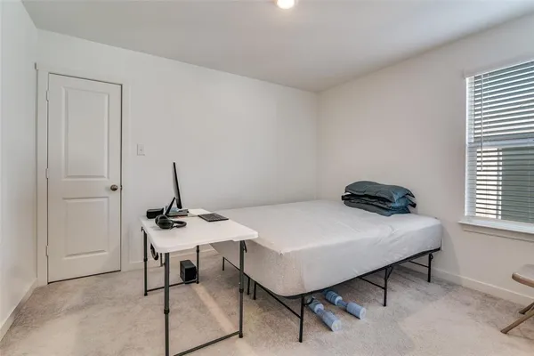 a bedroom with a table and chairs