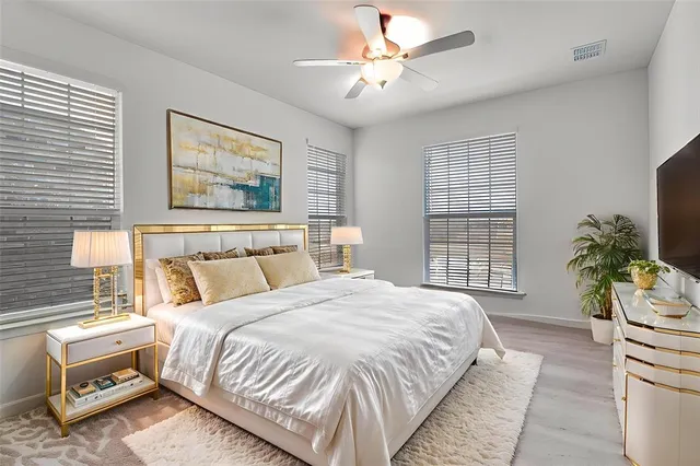 a bedroom with a bed chair and a window