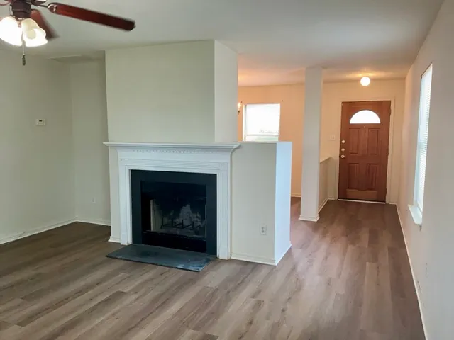wooden floor fireplace and natural light in room