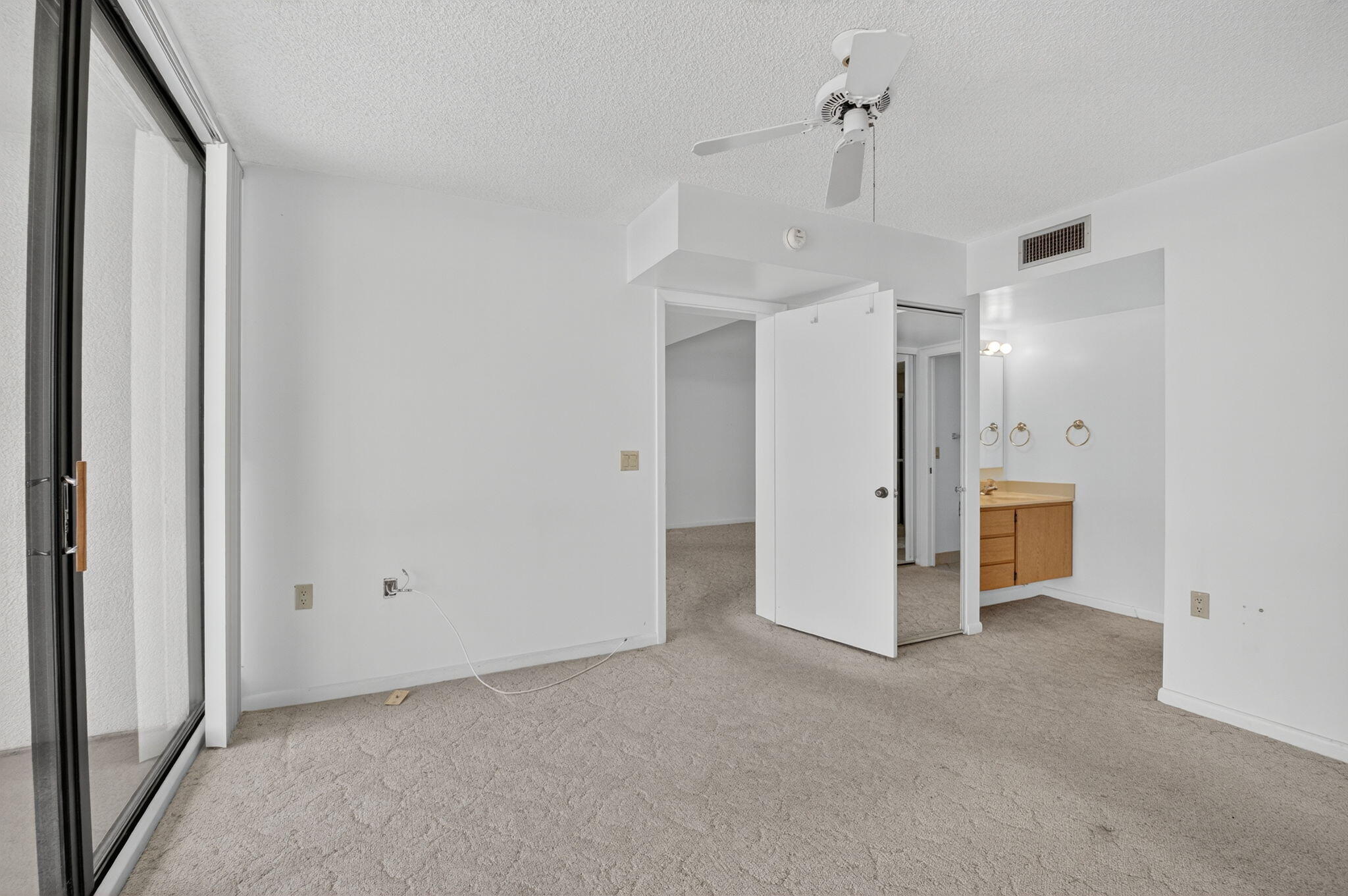 6193 Balboa Circle, Unit 403 Boca Raton, FL 33433 - Photo 11 of 25 a view of a big room with closet and chandelier fan