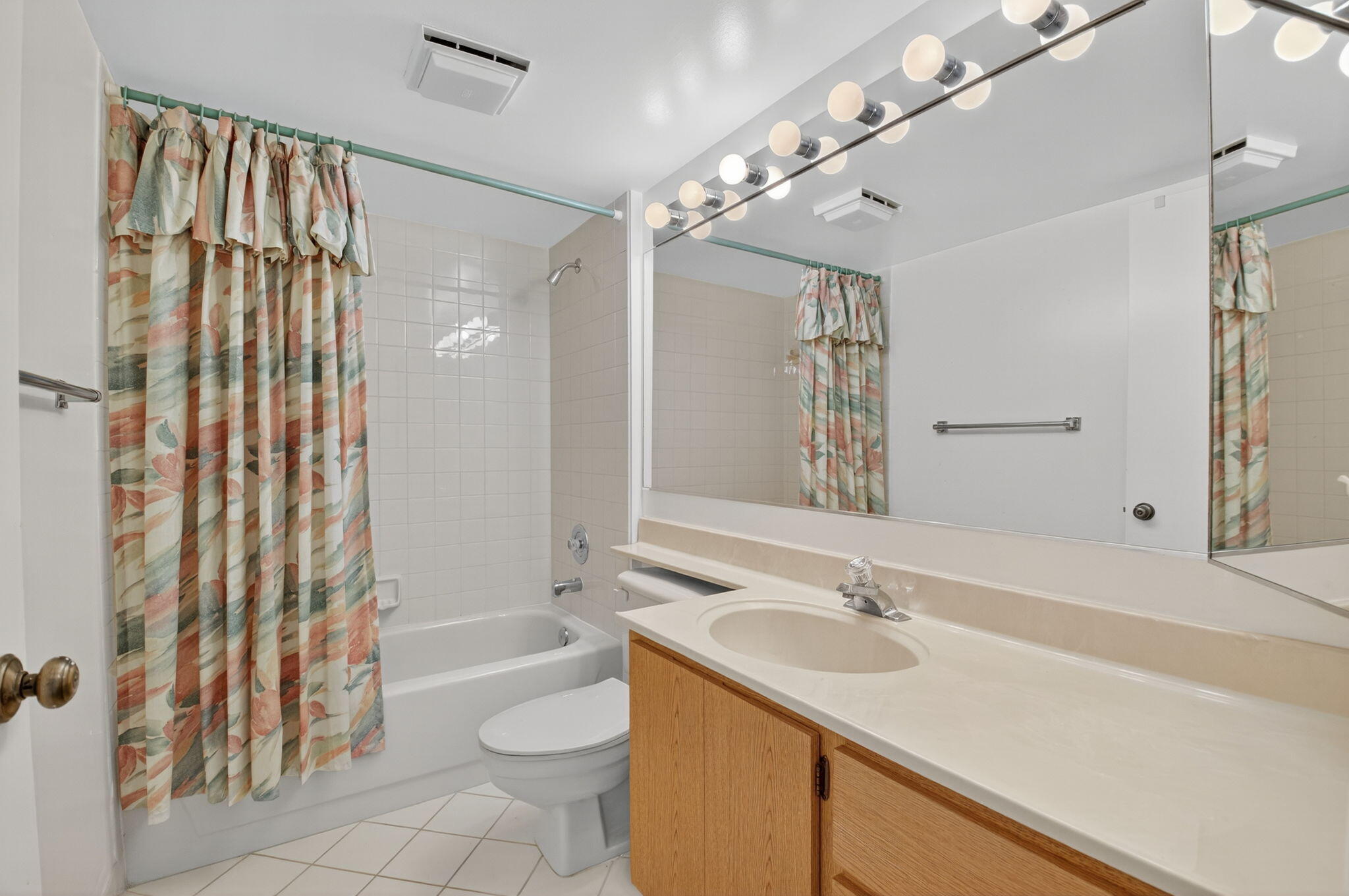 6193 Balboa Circle, Unit 403 Boca Raton, FL 33433 - Photo 15 of 25 a bathroom with a sink a toilet a mirror a vanity and shower