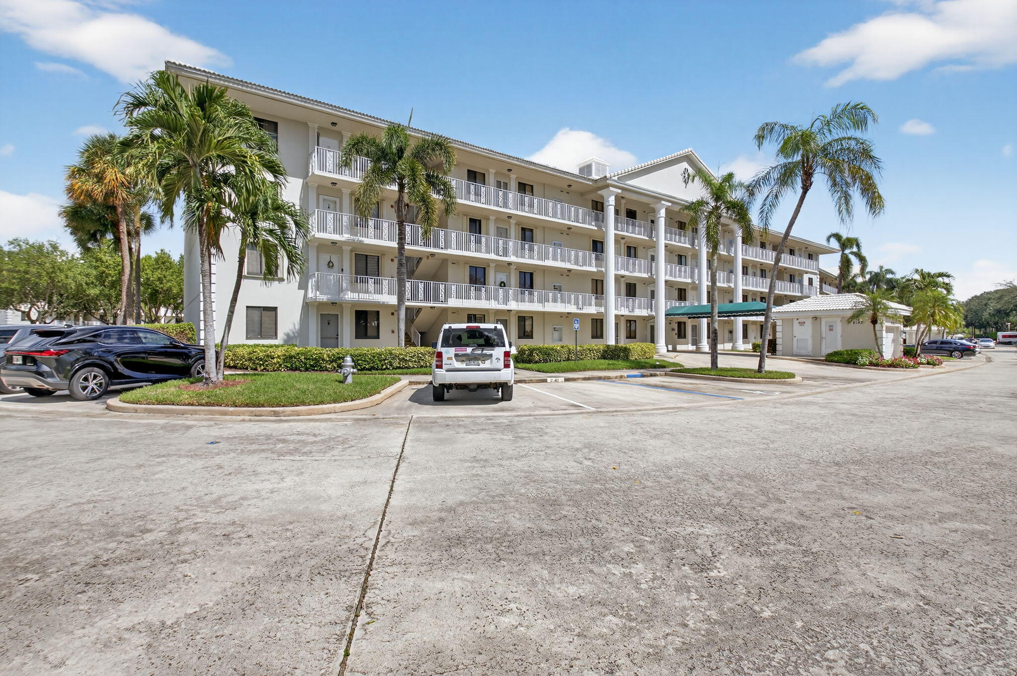 6193 Balboa Circle, Unit 403 Boca Raton, FL 33433 - Photo 2 of 25 a front view of building with cars parked