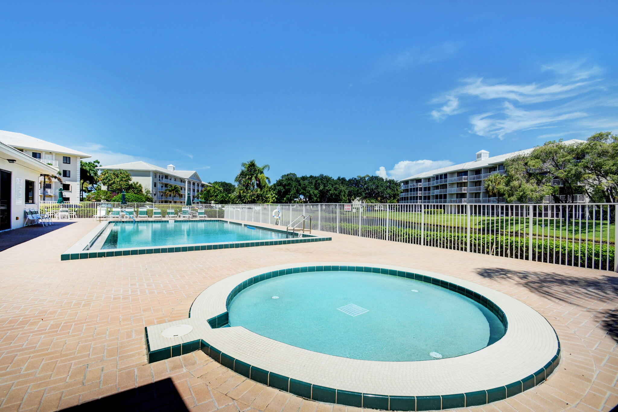 6193 Balboa Circle, Unit 403 Boca Raton, FL 33433 - Photo 21 of 25 a view of a swimming pool with an outdoor seating