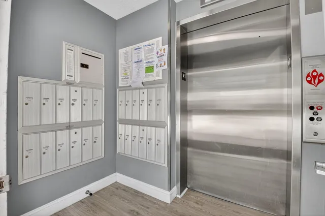 a view of a hallway with wooden floor and entryway