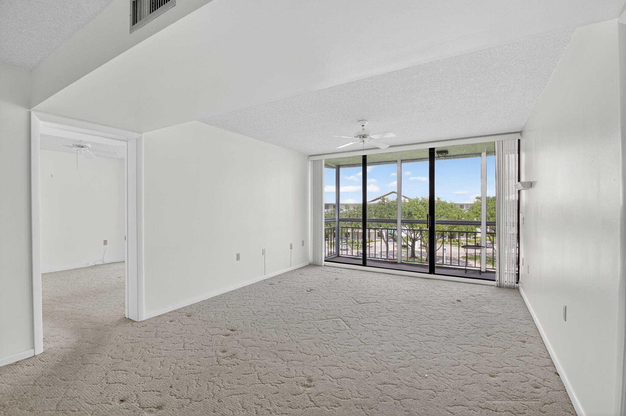 6193 Balboa Circle, Unit 403 Boca Raton, FL 33433 - Photo 5 of 25 a view of an empty room with a balcony