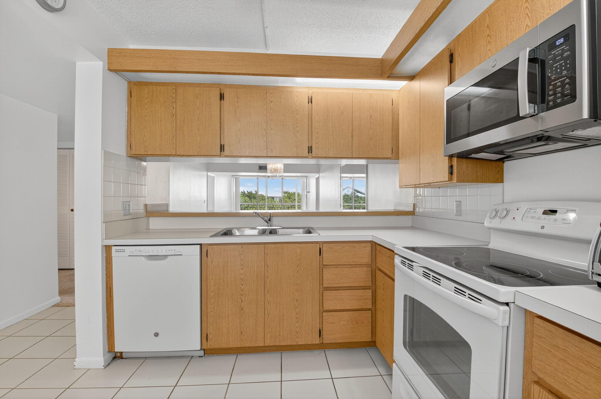 6193 Balboa Circle, Unit 403 Boca Raton, FL 33433 - Photo 9 of 25 a kitchen with stainless steel appliances granite countertop a sink and cabinets