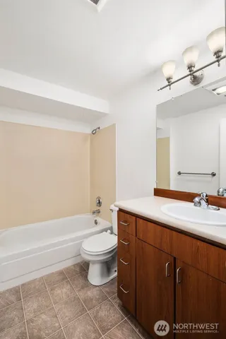 a bathroom with a sink a toilet and bathtub