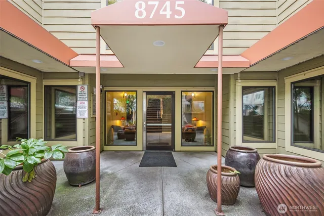 a front view of a house with outdoor seating and a potted plant