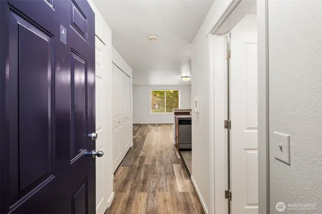 a view of hallway with wooden floor