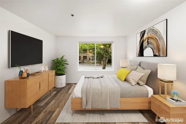 a bedroom with a bed and a flat screen tv