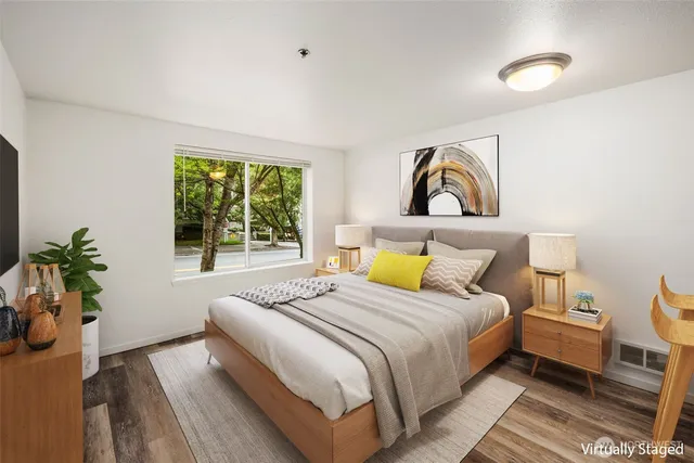 a bedroom with a bed and wooden floor