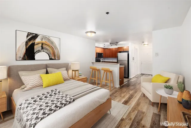 a bedroom with a bed and wooden floor