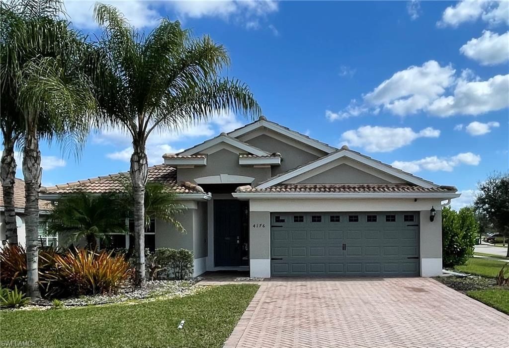 a front view of house with yard and green space