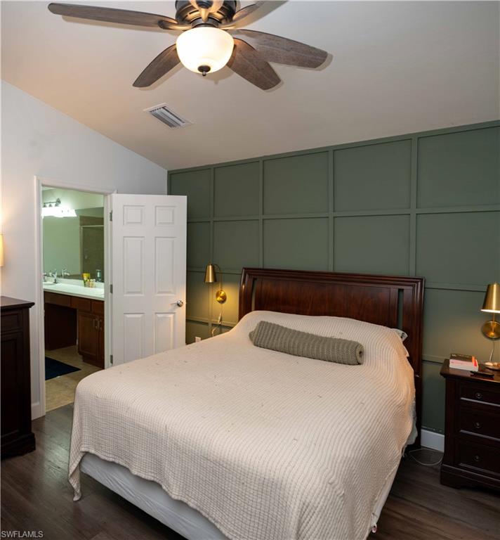 4176 Madison Street Ave Maria, FL 34142 - Photo 11 of 17 a bedroom with a bed and a chandelier