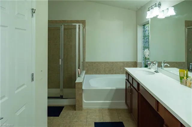 a bathroom with a tub sink and mirror