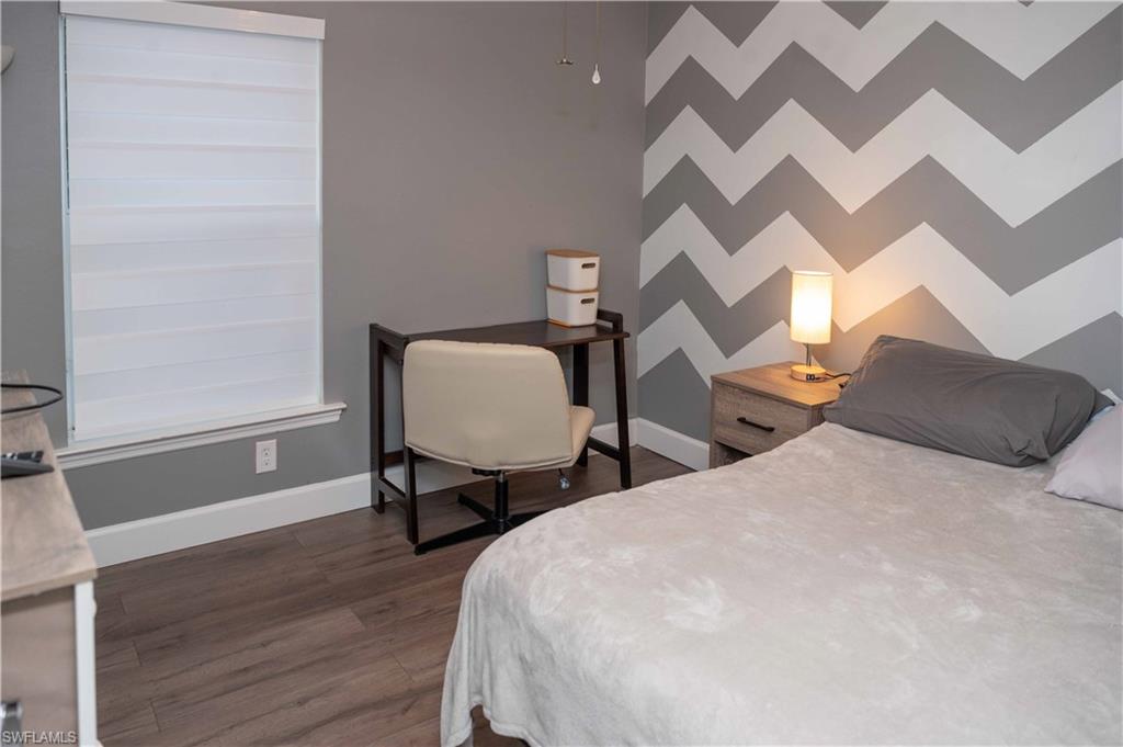 4176 Madison Street Ave Maria, FL 34142 - Photo 15 of 17 a bedroom with two beds and a table