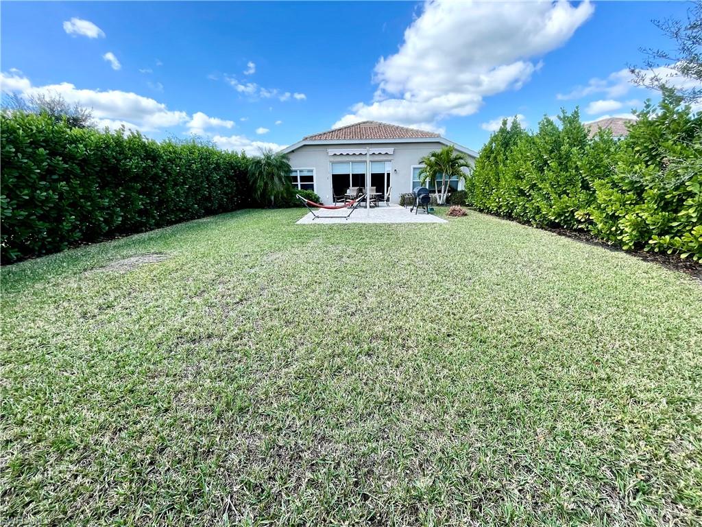 4176 Madison Street Ave Maria, FL 34142 - Photo 4 of 17 a front view of a house with garden