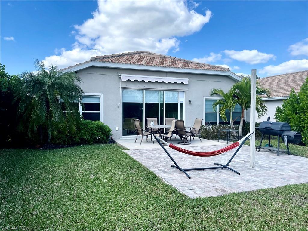 4176 Madison Street Ave Maria, FL 34142 - Photo 5 of 17 a view of a house with backyard porch and patio