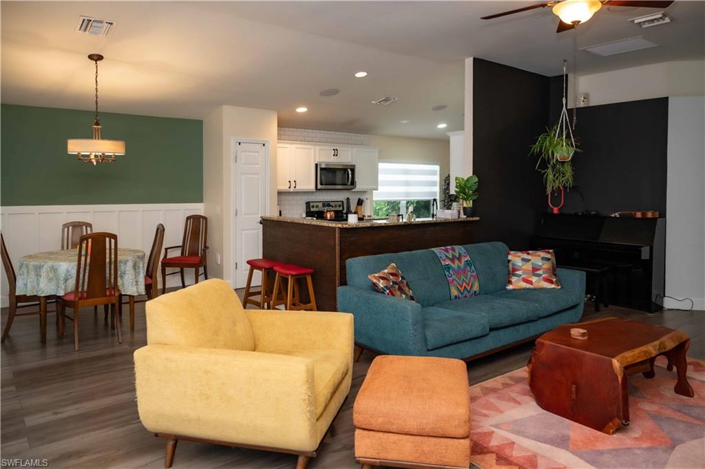 4176 Madison Street Ave Maria, FL 34142 - Photo 9 of 17 a living room with furniture and a flat screen tv