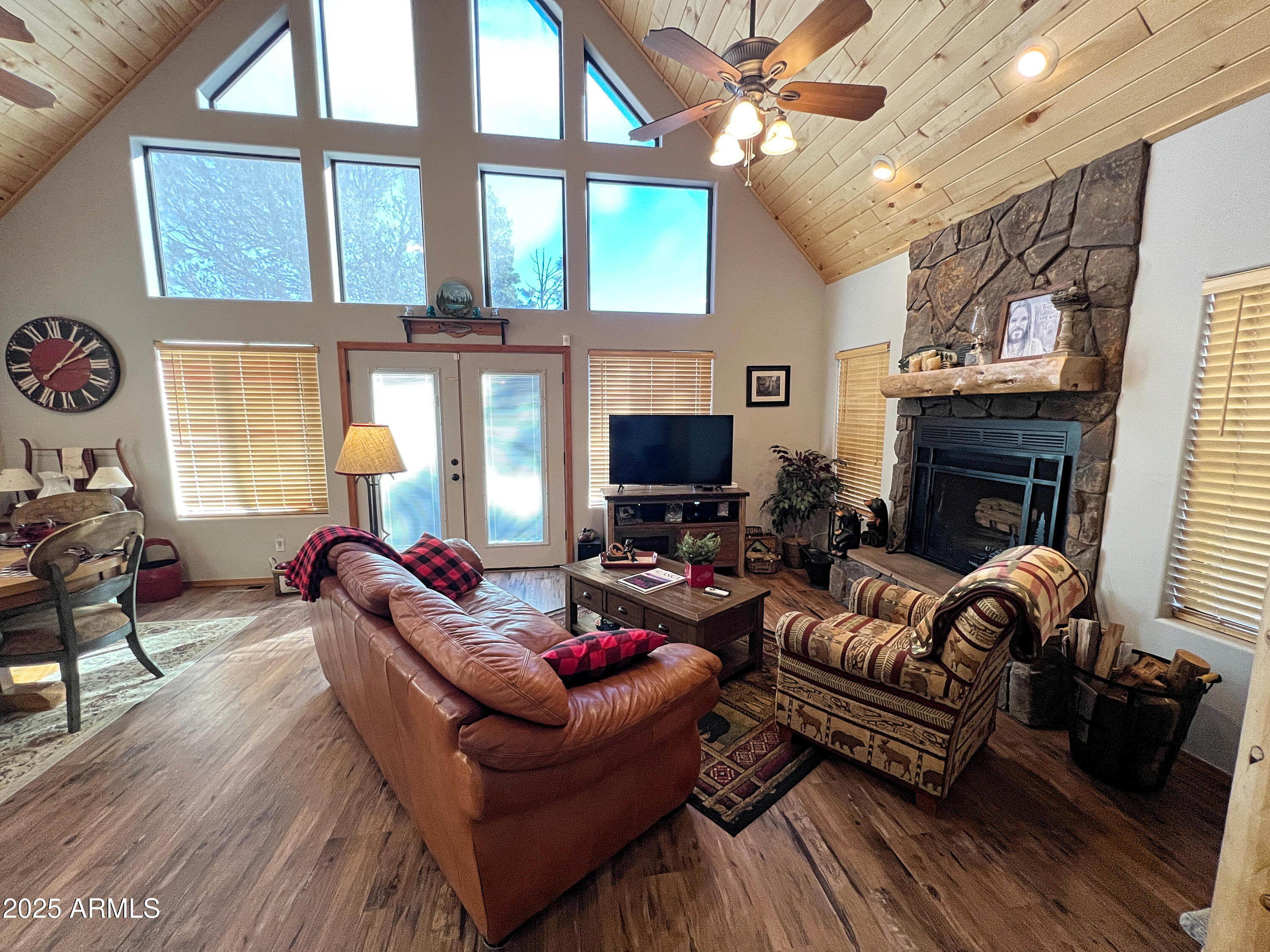 2240 Fairway Drive Overgaard, AZ 85933 - Photo 1 of 51 a living room with furniture a fireplace and a flat screen tv
