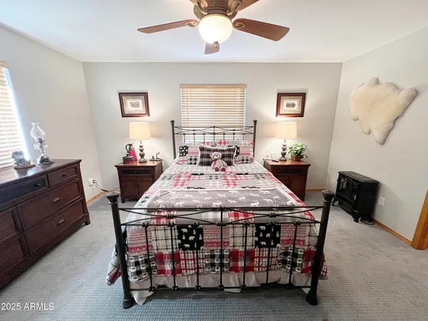 a bedroom with a bed a window and dresser