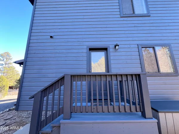 a view of a balcony with wooden floor and fence