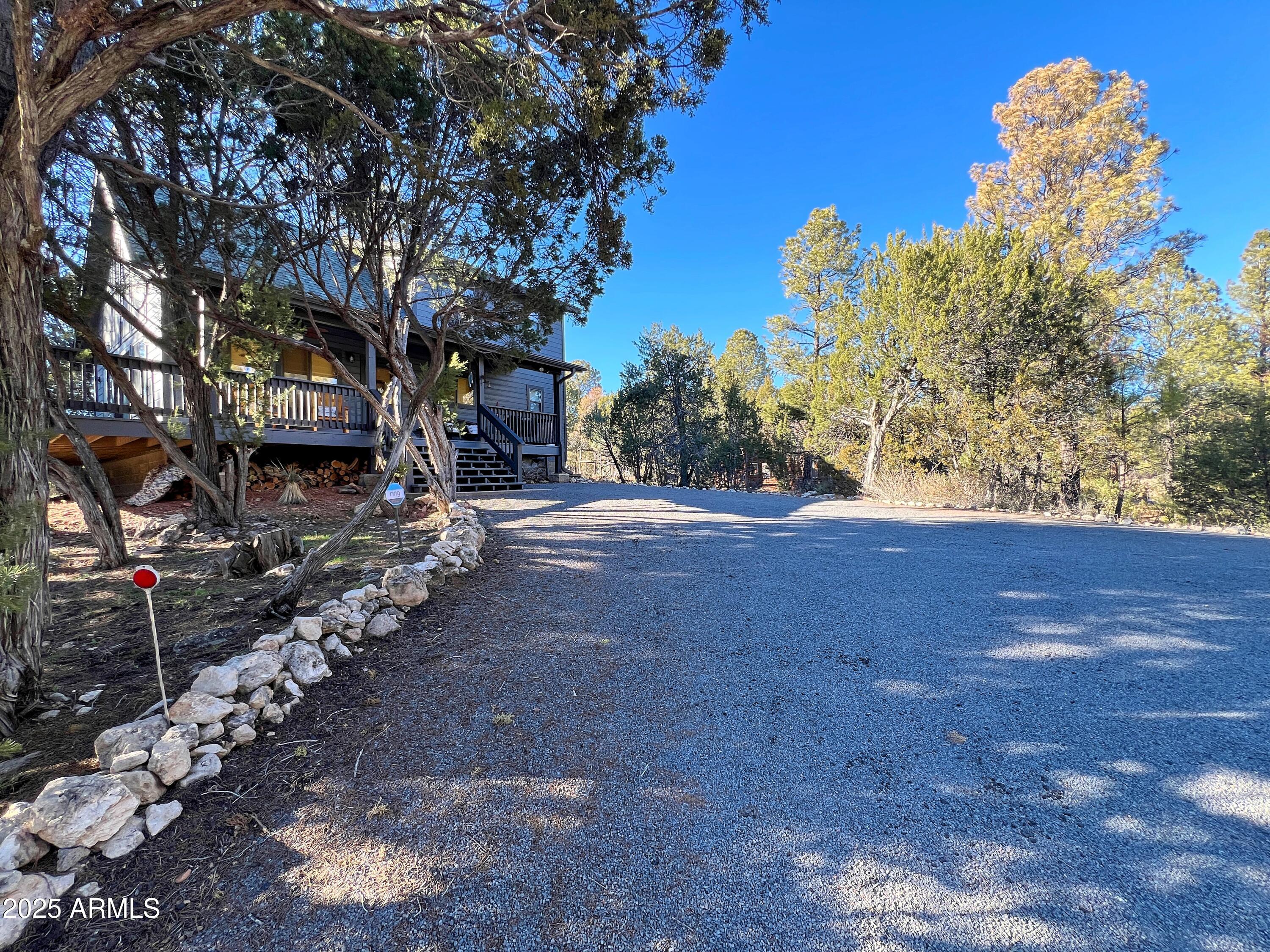 2240 Fairway Drive Overgaard, AZ 85933 - Photo 5 of 51 a wooden fence with some trees in the background