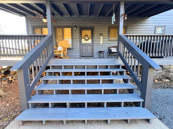 a view of staircase with wooden floor and white walls