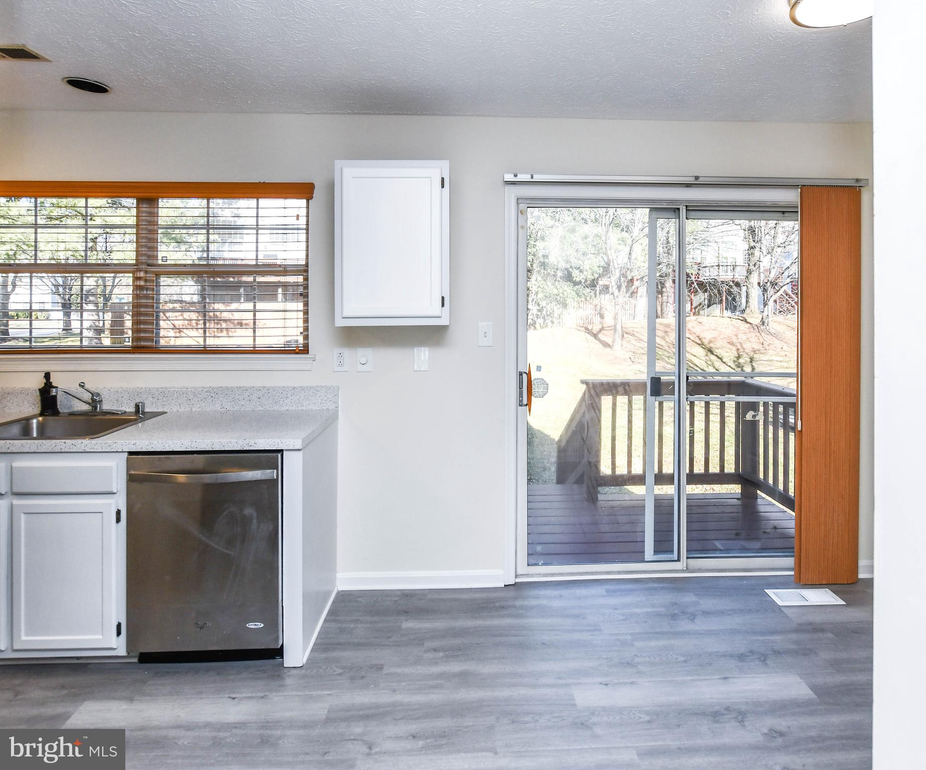 5908 Grenfell Loop Bowie, MD 20720 - Photo 12 of 65 a view of an empty room with a window and wooden floor