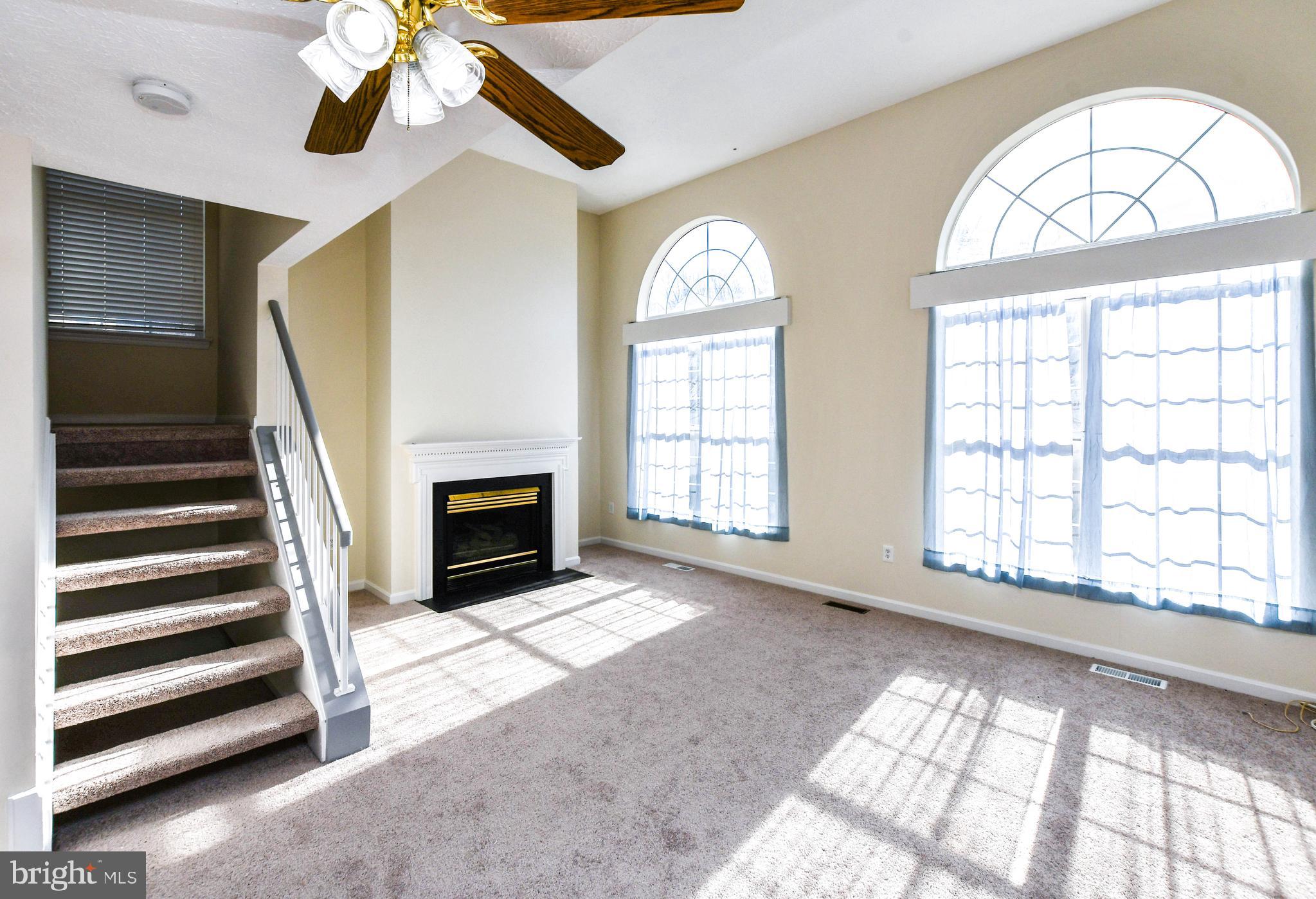 5908 Grenfell Loop Bowie, MD 20720 - Photo 27 of 65 a view of an empty room with wooden floor fan and a window