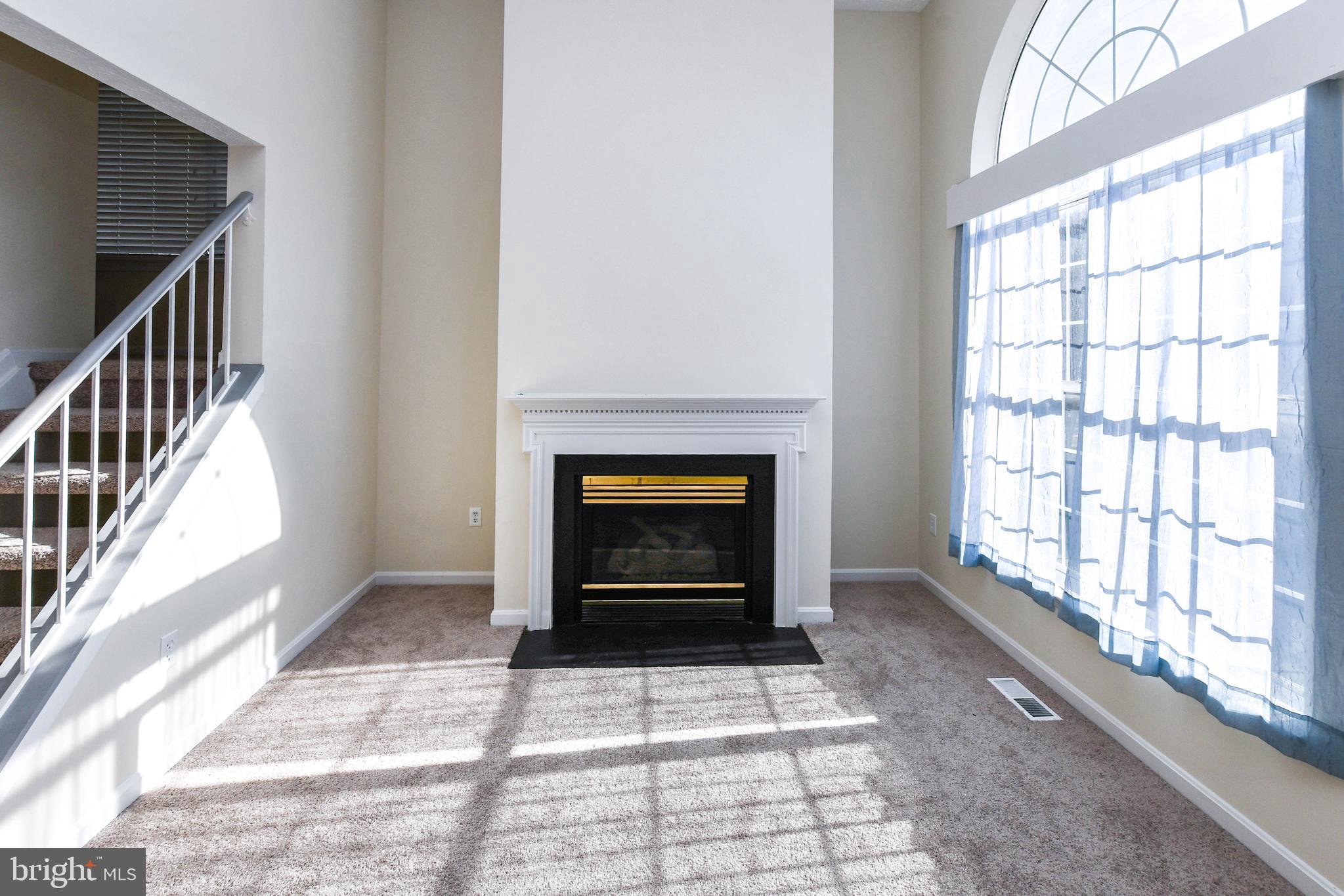 5908 Grenfell Loop Bowie, MD 20720 - Photo 29 of 65 a view of an empty room with a window and fire place