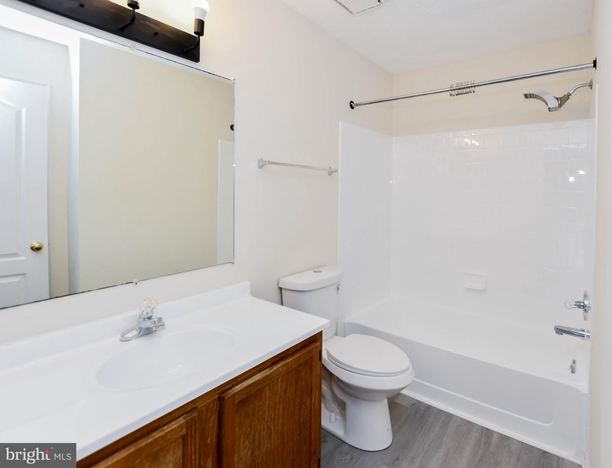 5908 Grenfell Loop Bowie, MD 20720 - Photo 33 of 65 a bathroom with a sink a toilet and shower