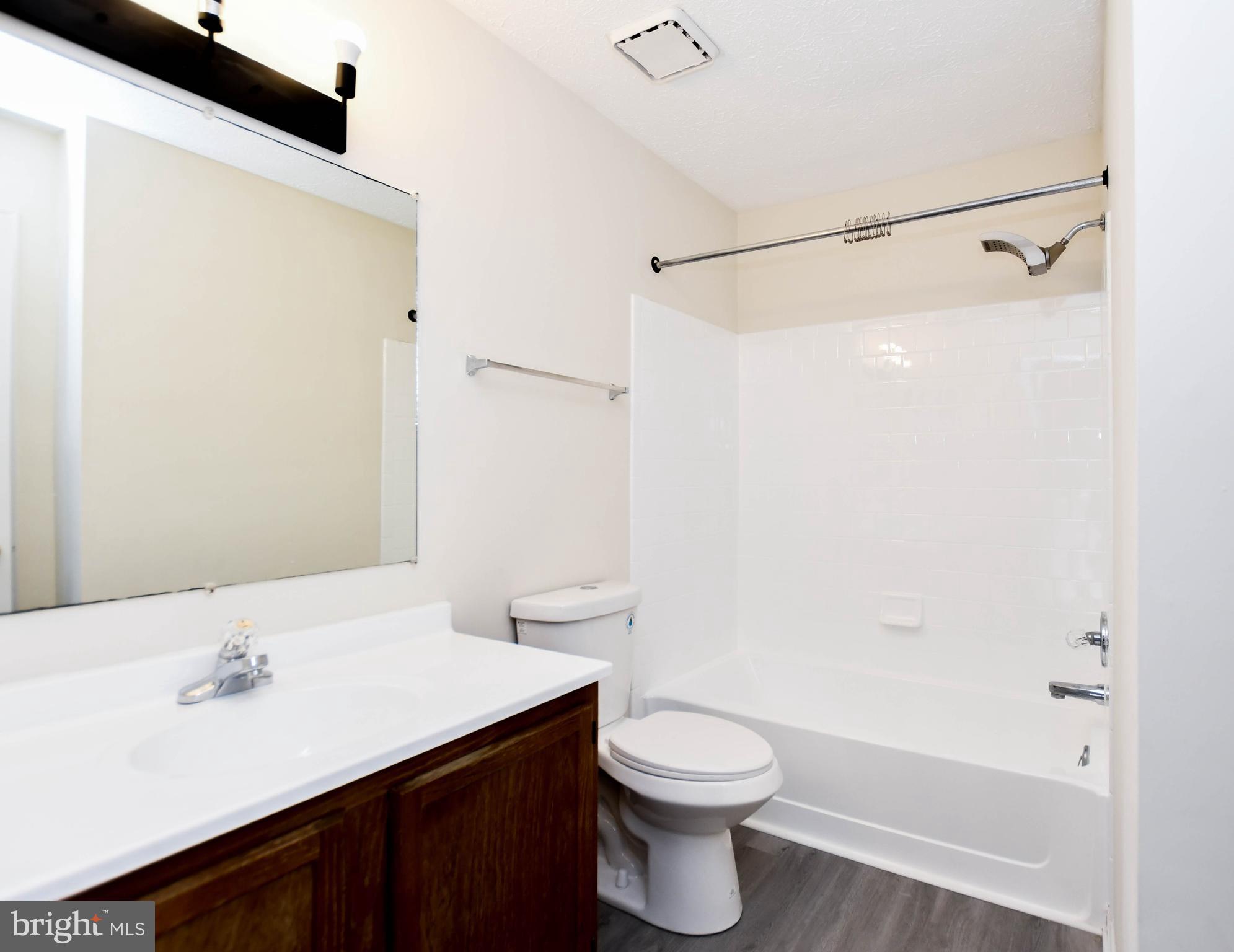 5908 Grenfell Loop Bowie, MD 20720 - Photo 34 of 65 a bathroom with a sink a toilet and shower