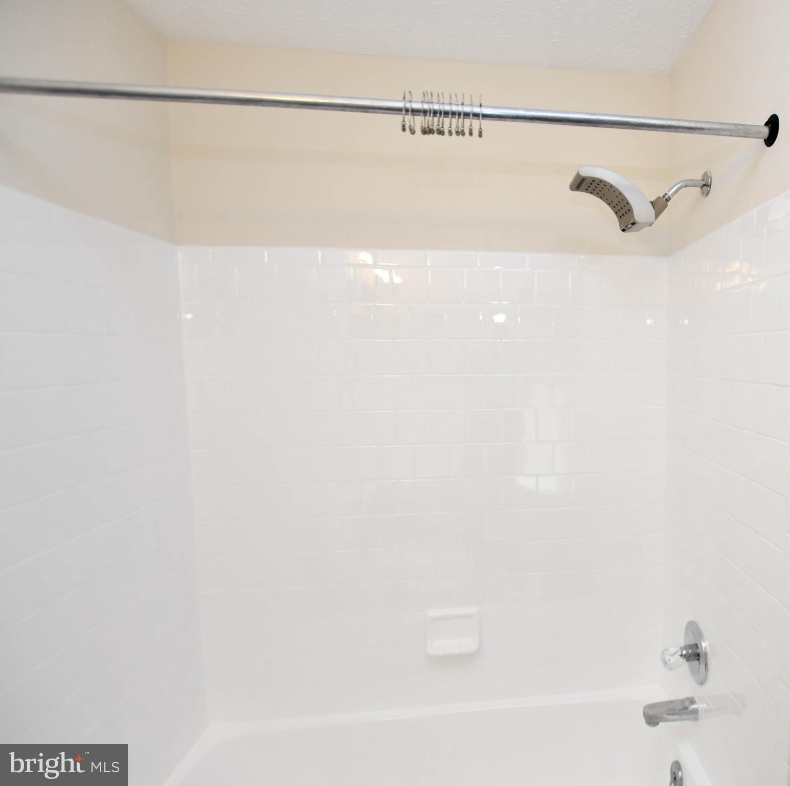 5908 Grenfell Loop Bowie, MD 20720 - Photo 35 of 65 a bathroom with a shower and a bathtub