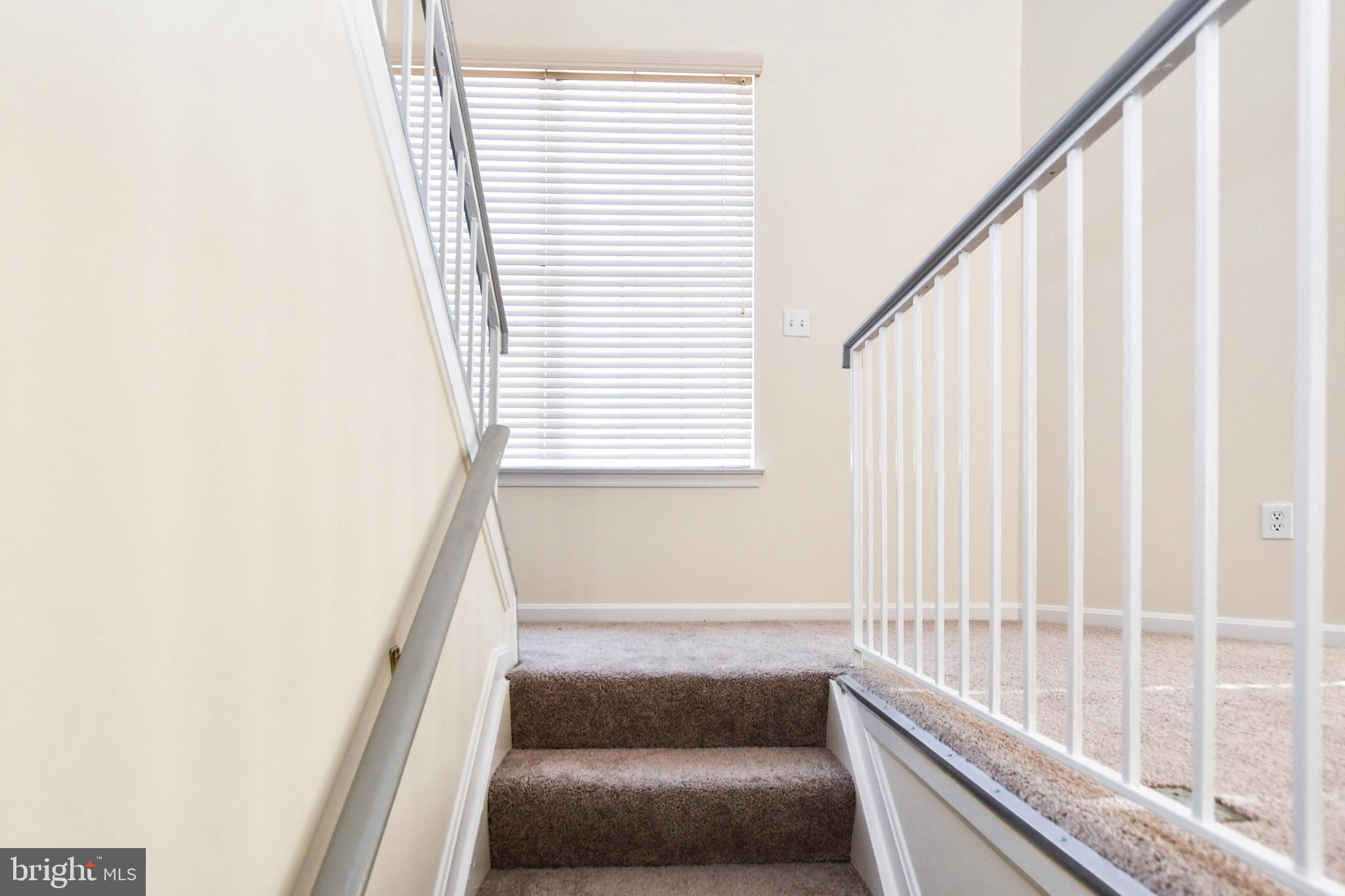 5908 Grenfell Loop Bowie, MD 20720 - Photo 42 of 65 a view of staircase with rug and white walls