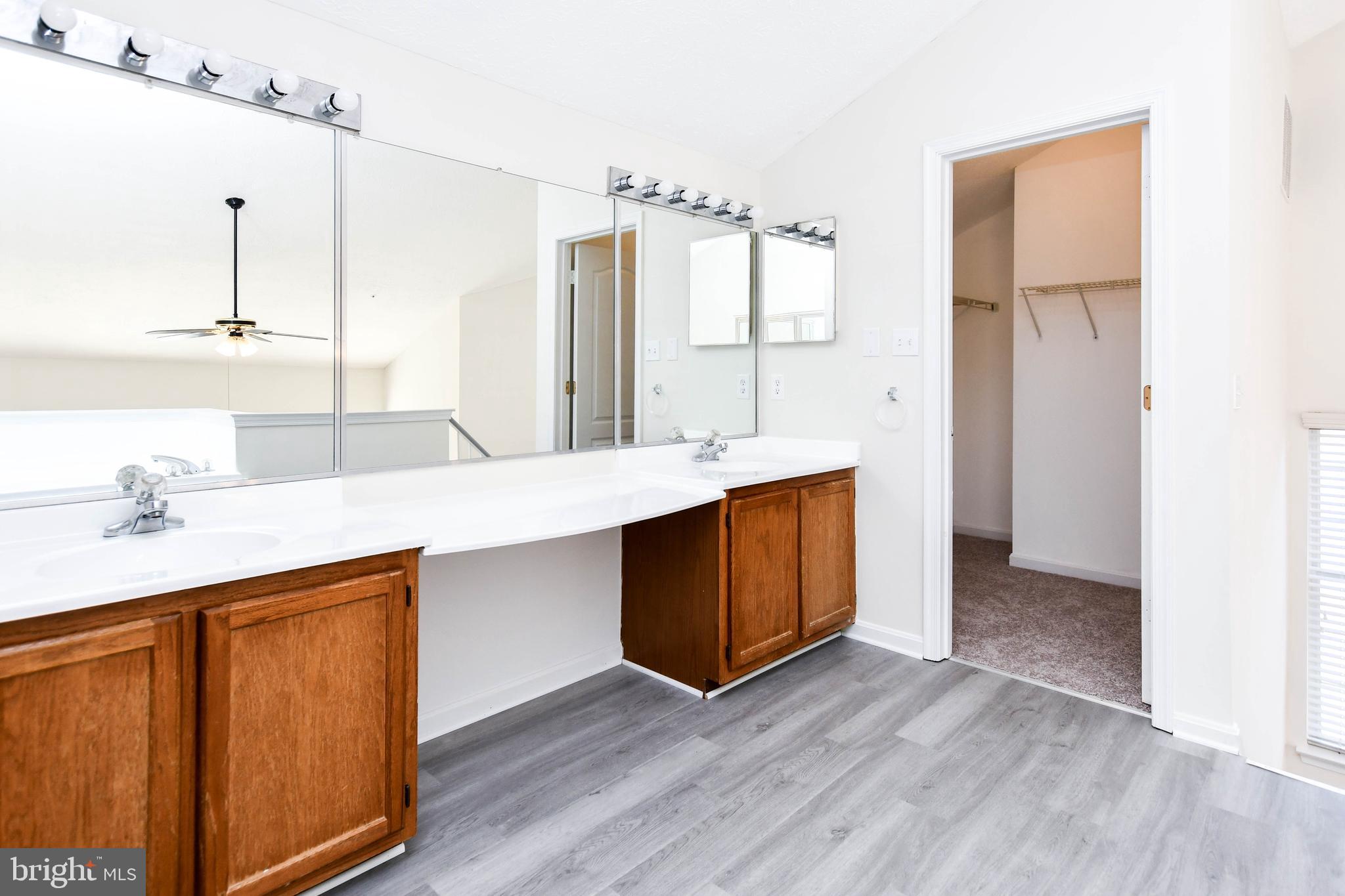 5908 Grenfell Loop Bowie, MD 20720 - Photo 50 of 65 a bathroom with a double vanity sink and a mirror
