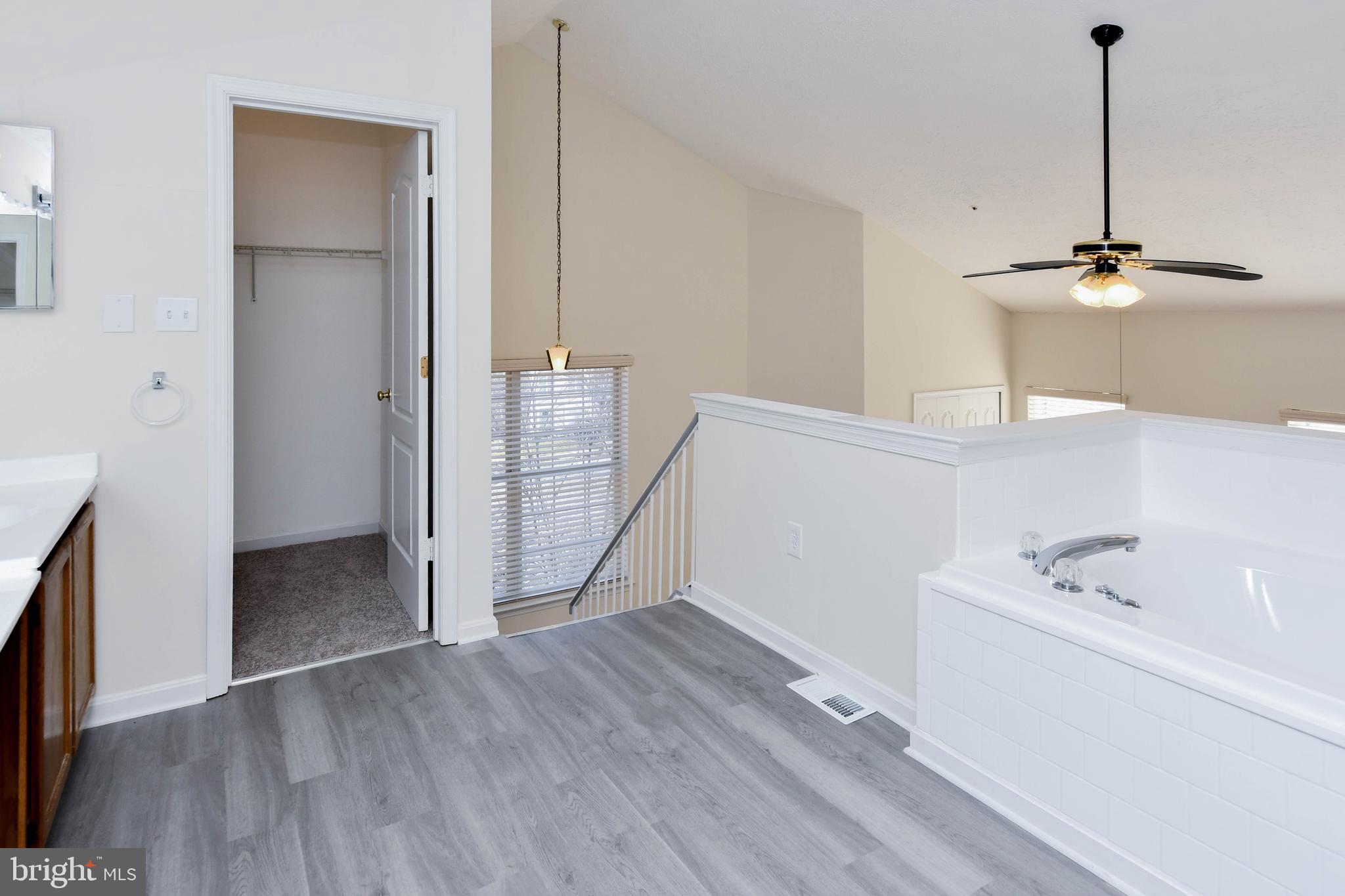 5908 Grenfell Loop Bowie, MD 20720 - Photo 52 of 65 a view of an empty room with a window and kitchen view